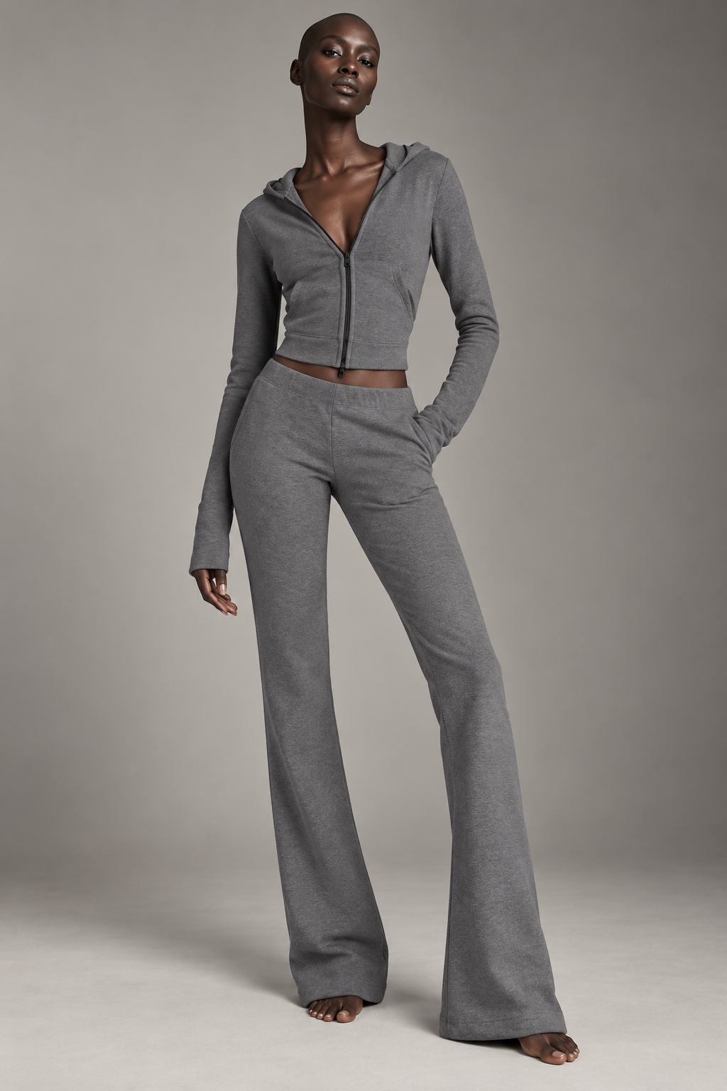 High-fashion model wearing The Sculpt Hooded Flare Set in grey